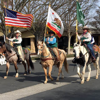Three horsemen with flags